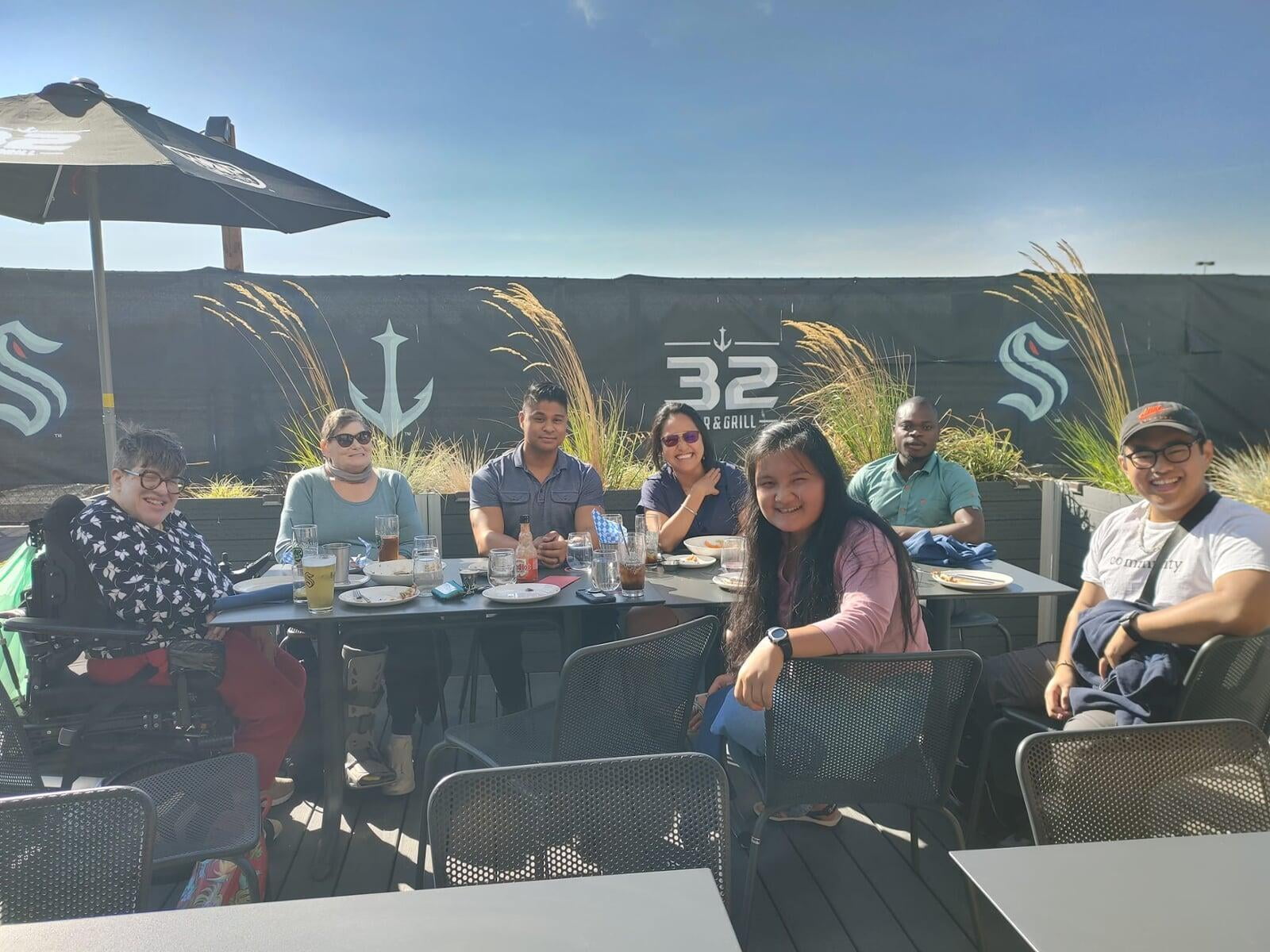 Talitha team and partners spending time together at a Seattle Kraken grill.