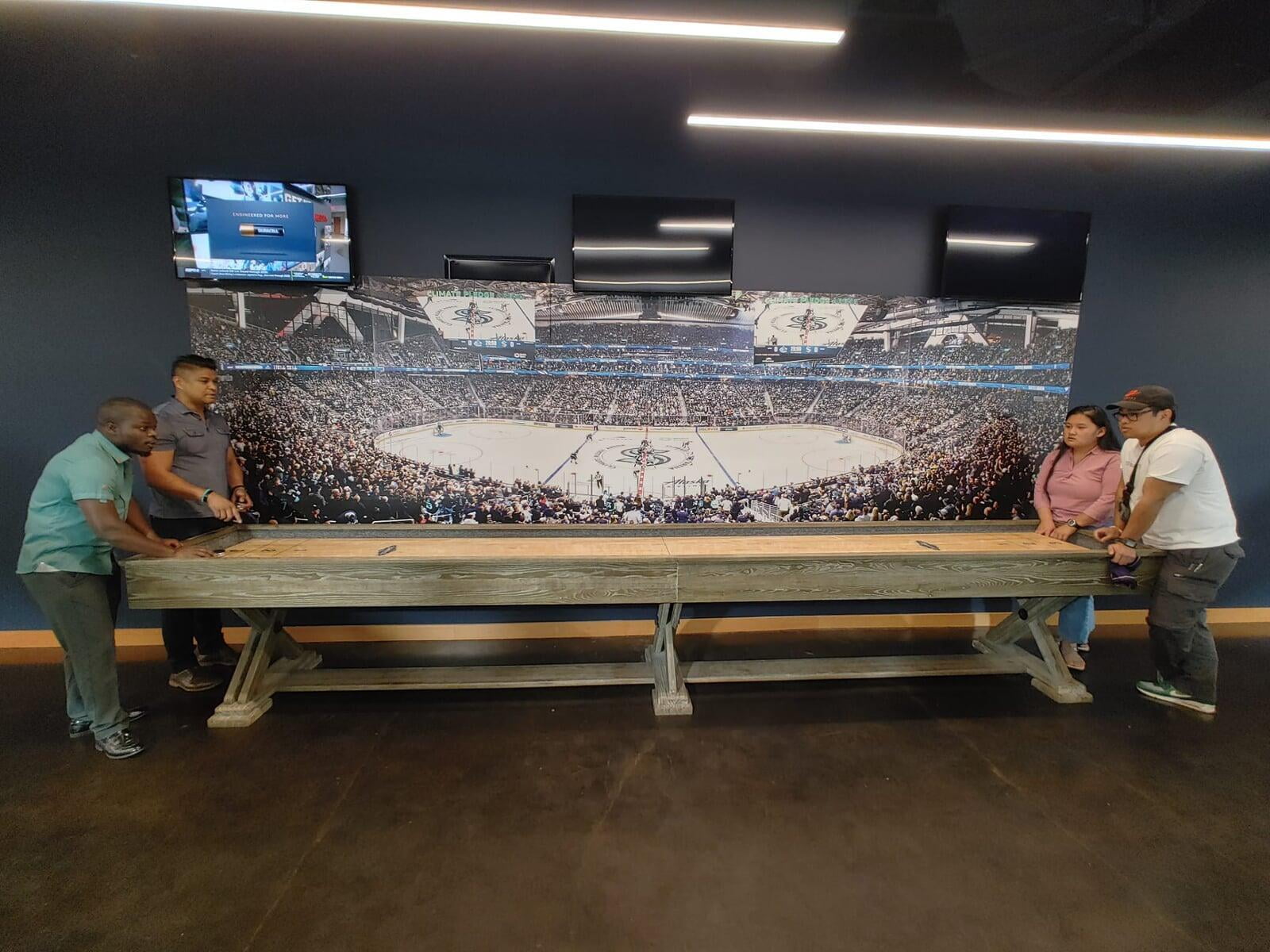 Olivier, Sean, Shawn, and Ehler playing table hockey together.