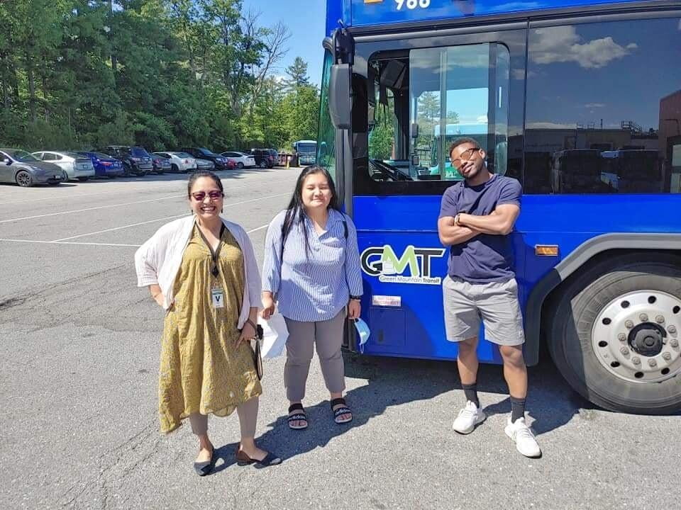 Charis, Ehler, and Mo, in front of of the Green Mountain Transit (GMT) bus. 
