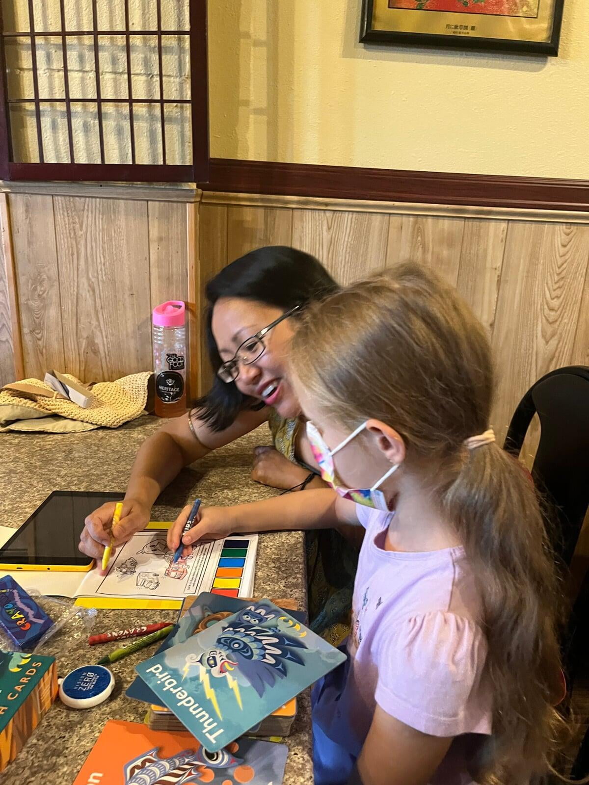 Charis and Karolina coloring together at an in-person meeting