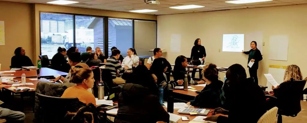 Charis May Hnin teaching a class.